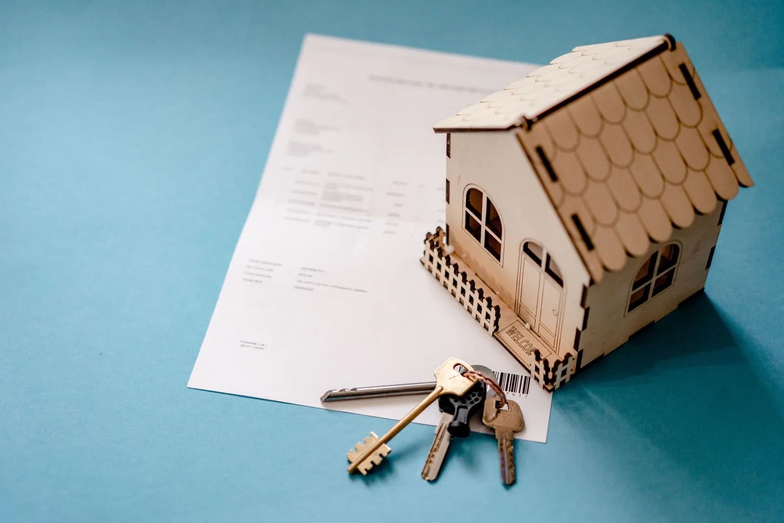 House keys resting on a signed contract